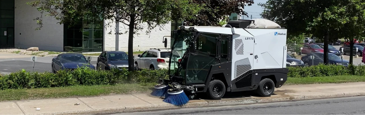 Madvac street sweeper on sidewalk