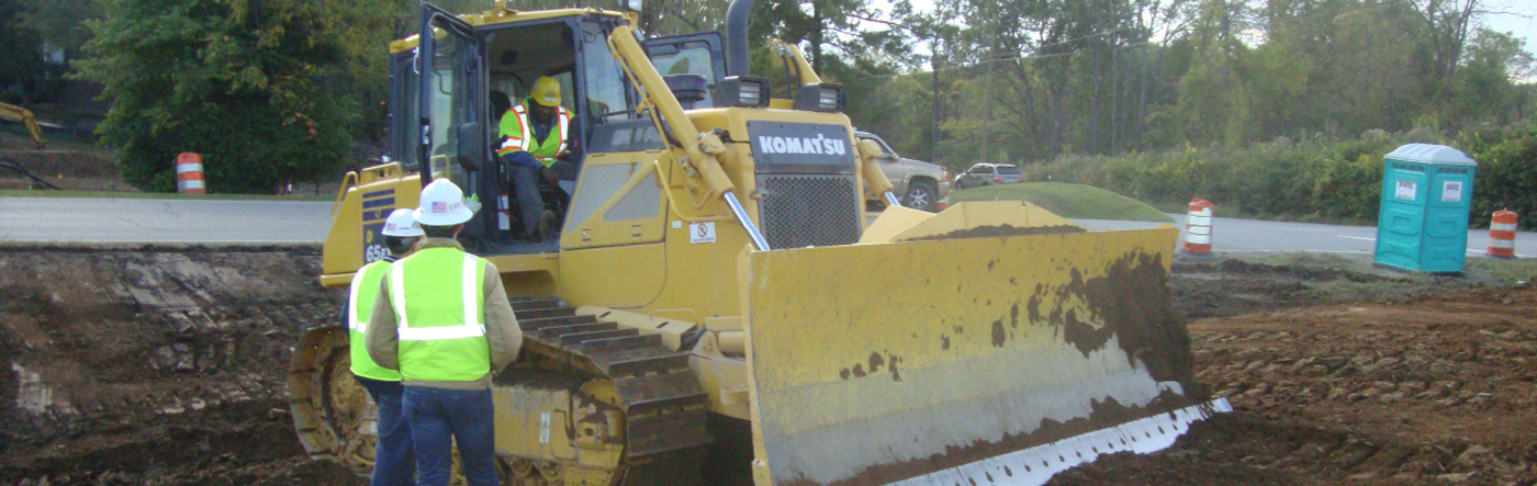 Photo of construction workers and Komatsu equipment