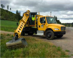 Gradall excavator clearing debris