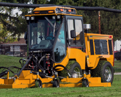 Trackless machine mowing field